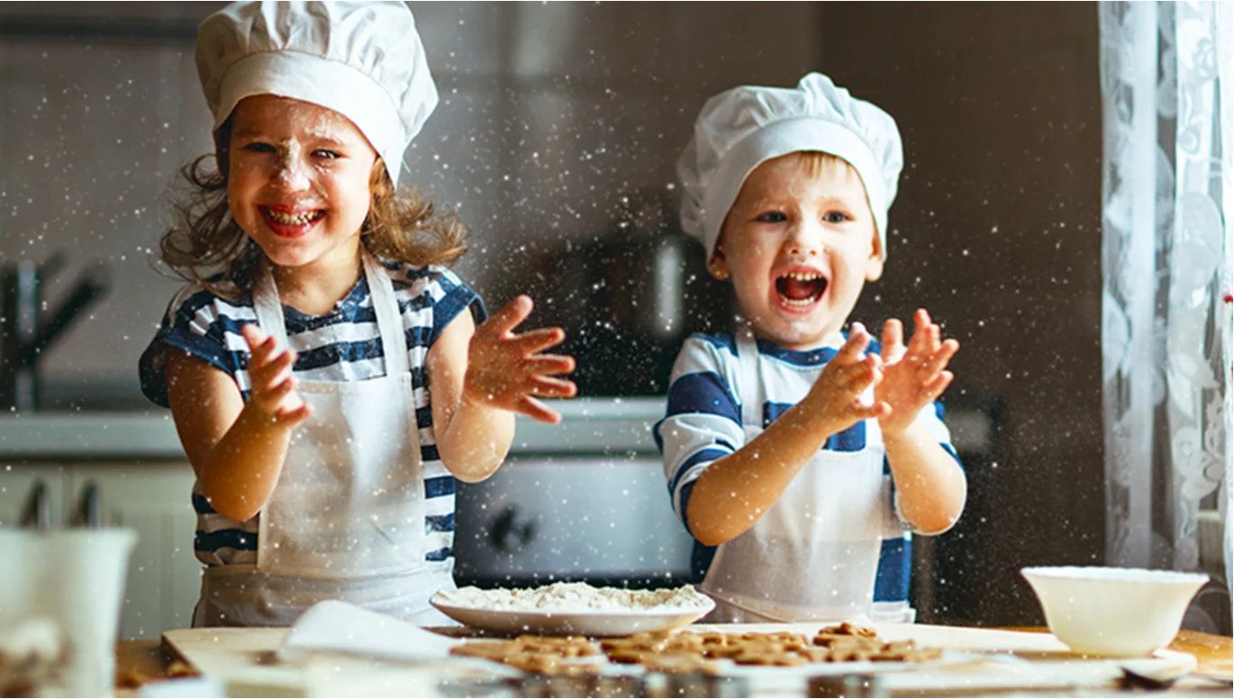 Children enjoying a cooking activity, representing the Quintessencia cooking school for kids.