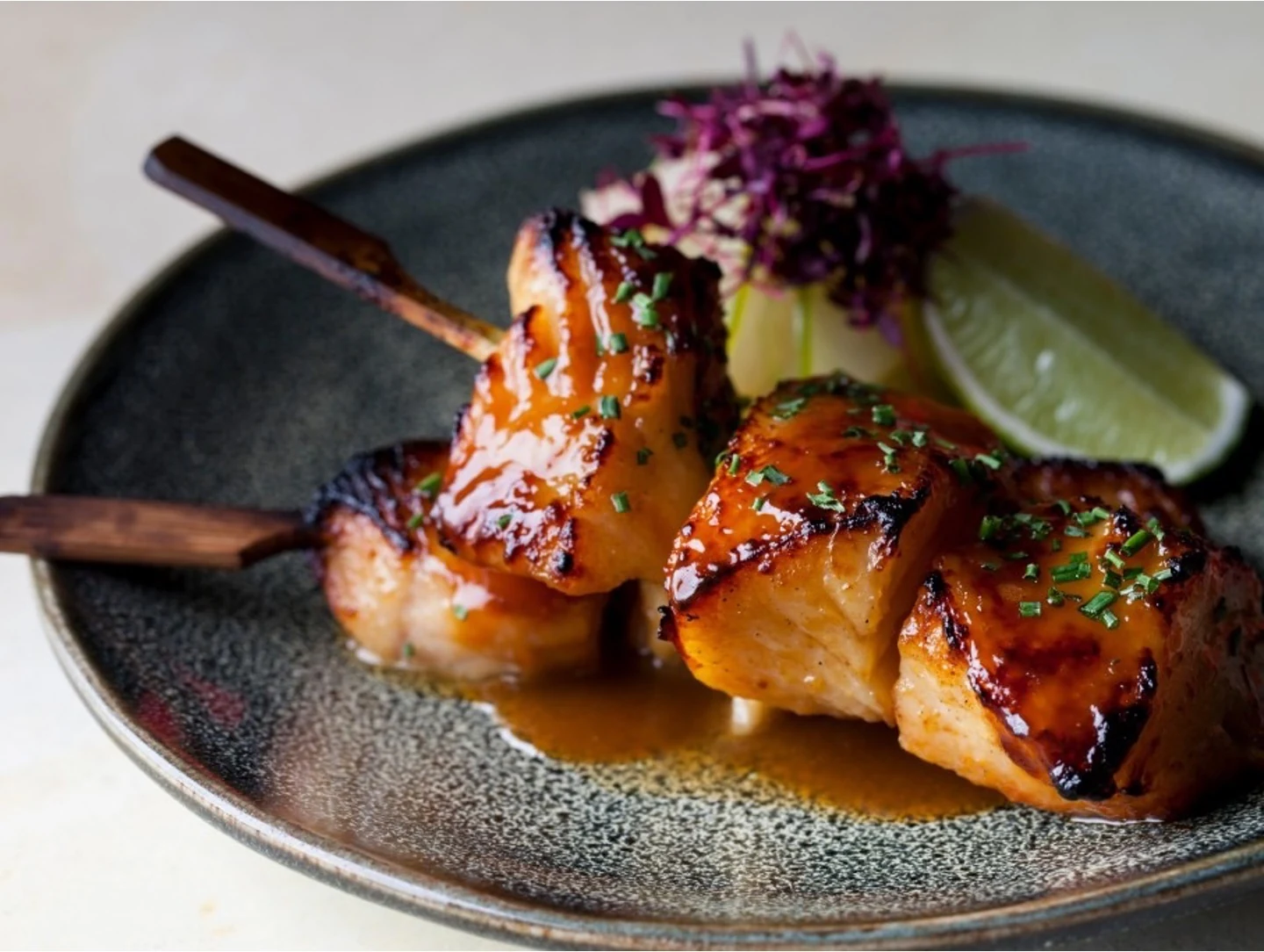 Glazed seafood skewers presented with refined simplicity, reflecting the range and quality of Quintessencia dining.